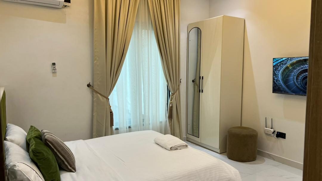 Bedroom with wardrobe and smart TV, Apartment Alpha, Nimbus Nook Ikeja GRA