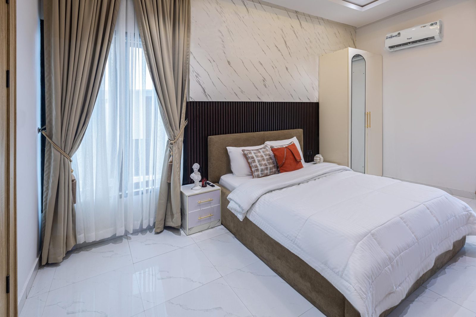 Bedroom with marble feature wall, Apartment Alpha, Nimbus Nook Ikeja GRA