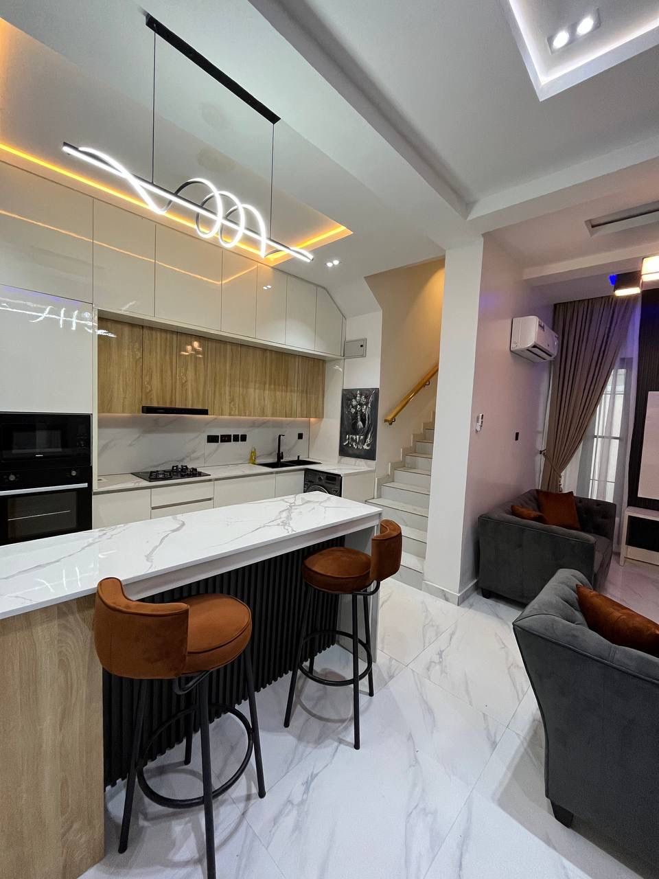 Kitchen island looking toward the lounge, Apartment Alpha, Nimbus Nook Ikeja GRA
