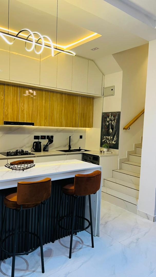 Kitchen island under pendant lighting, Apartment Alpha, Nimbus Nook Ikeja GRA
