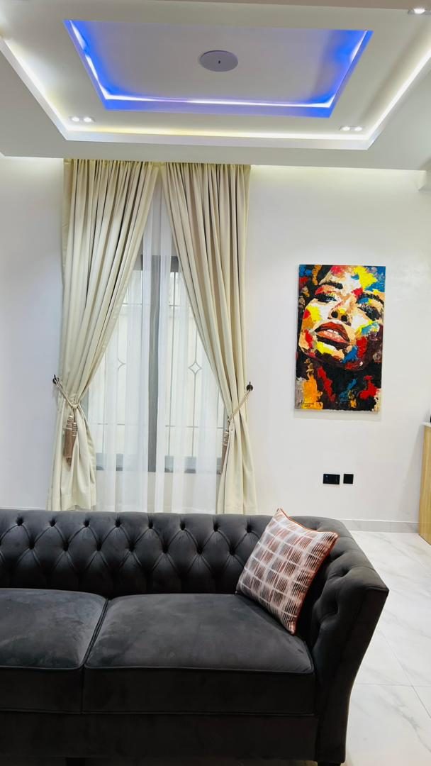 Velvet Chesterfield sofa and statement art, Apartment Alpha, Nimbus Nook Ikeja GRA