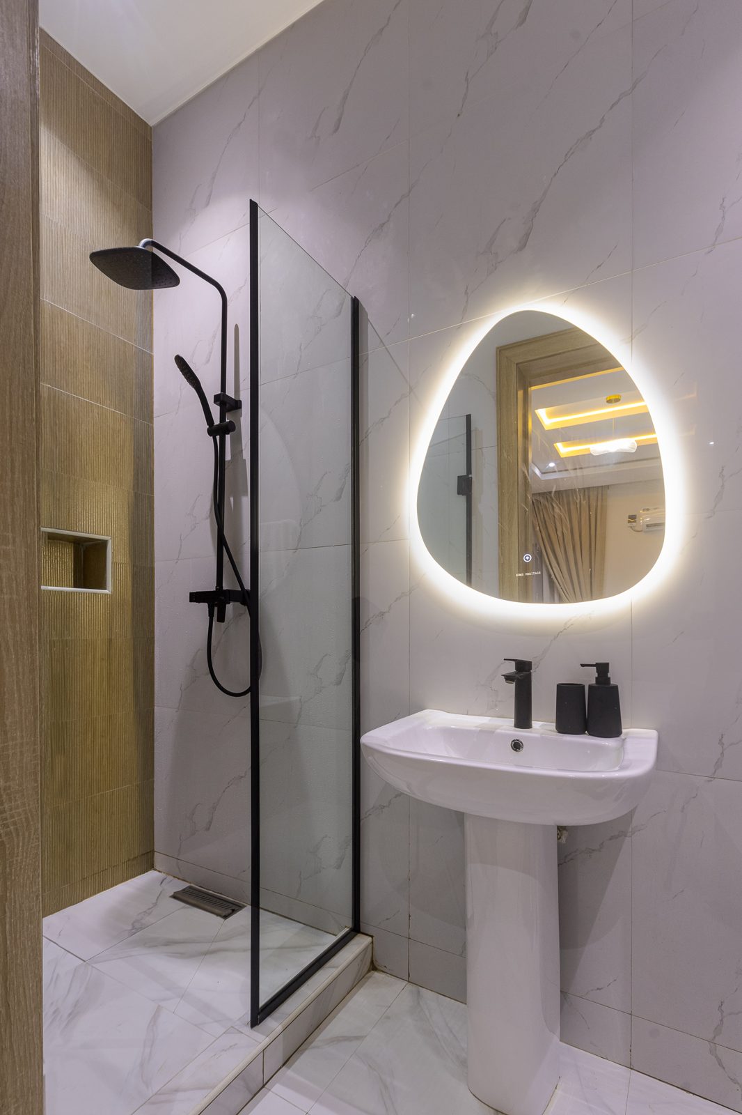 En-suite bathroom with illuminated mirror, Apartment Bravo, Nimbus Nook Ikeja GRA