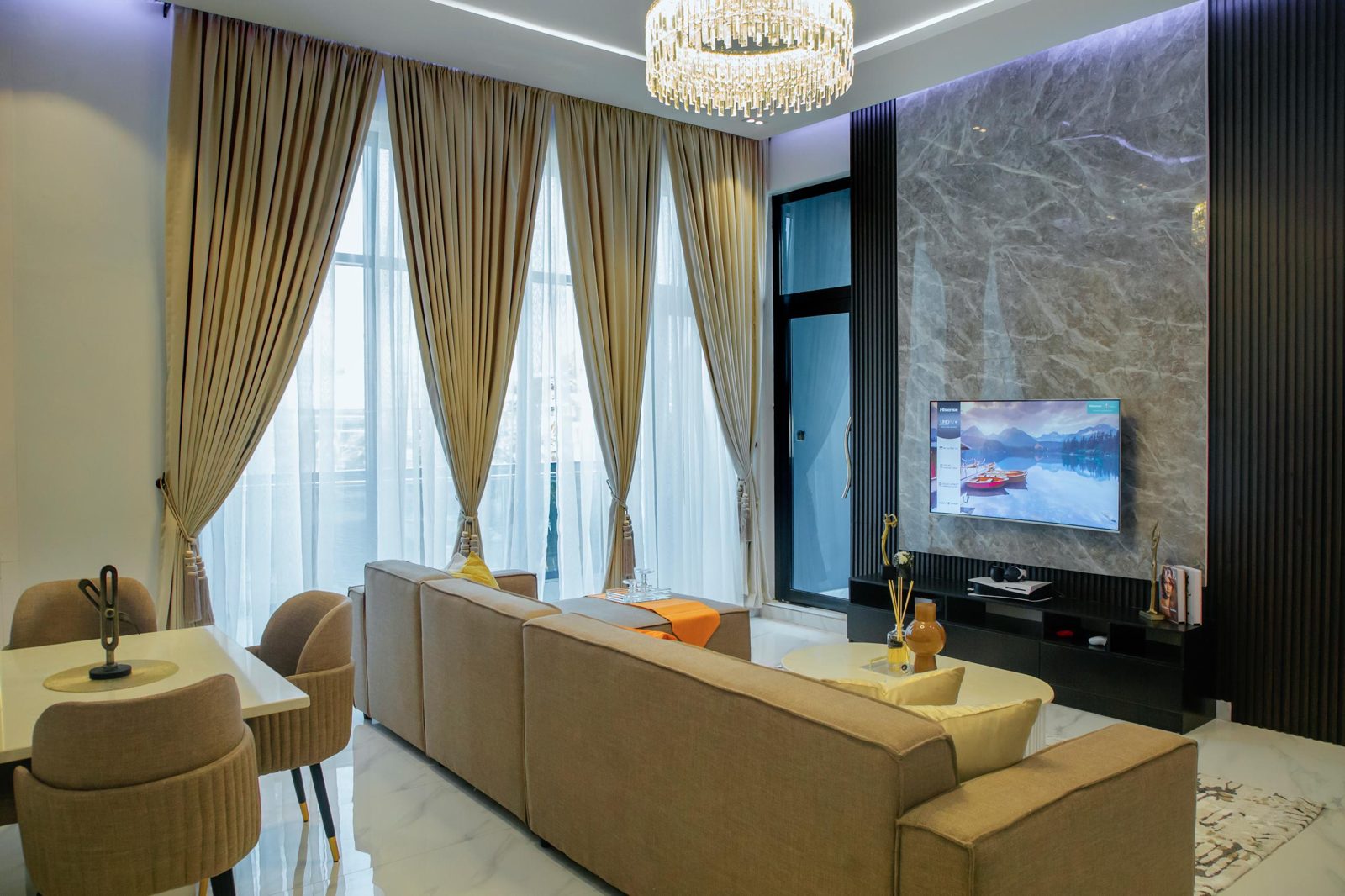 Living room with marble feature wall and crystal chandelier, Apartment Bravo, Nimbus Nook Ikeja GRA