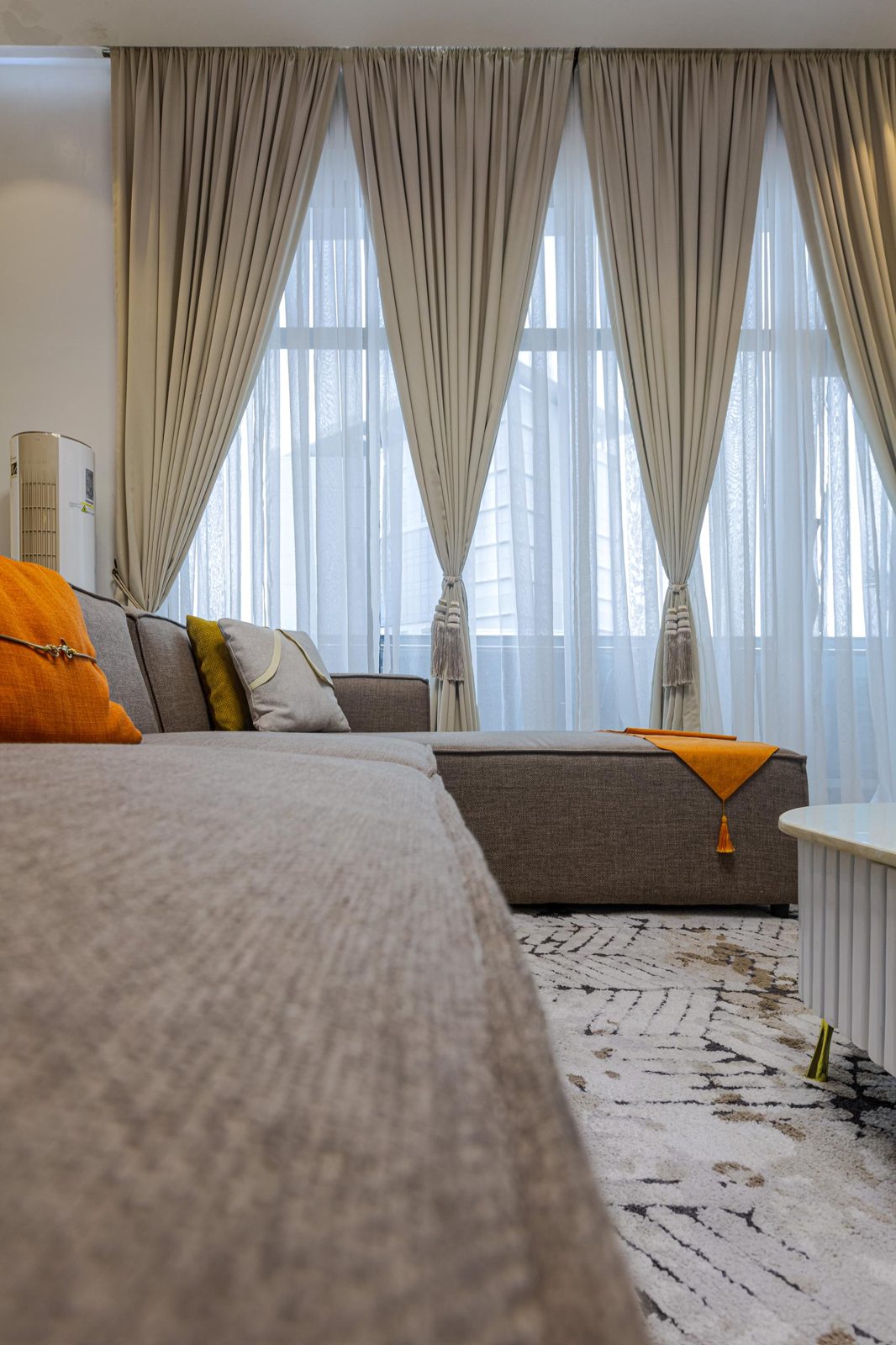 Sofa and floor-to-ceiling curtains, Apartment Bravo, Nimbus Nook Ikeja GRA