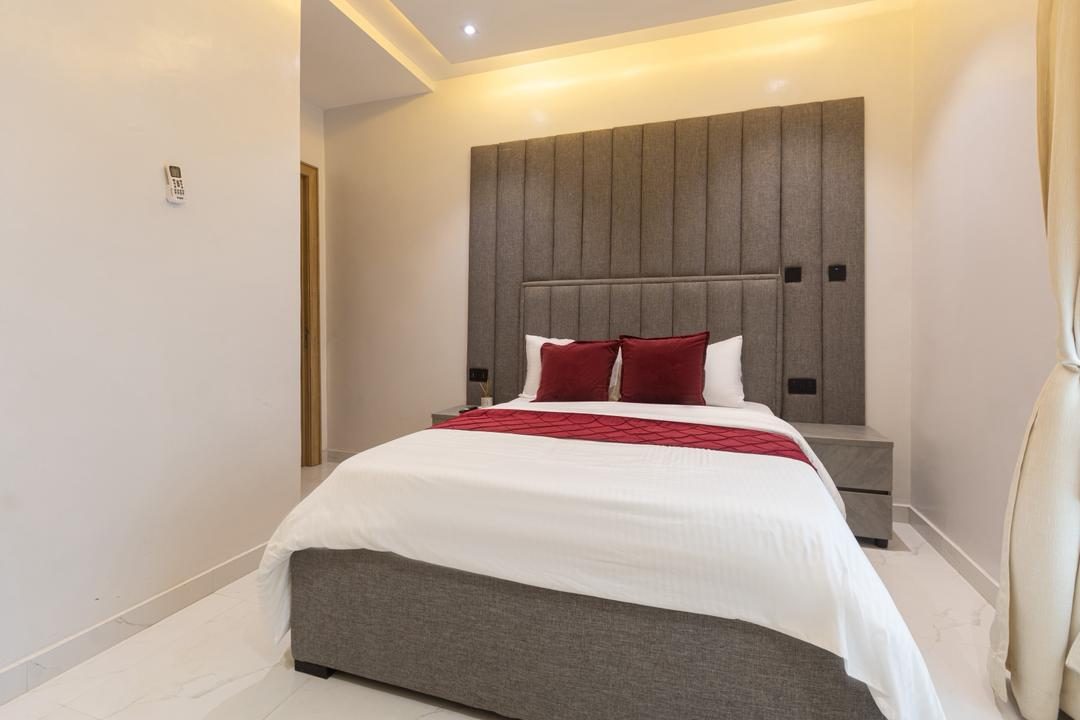 Bedroom with upholstered headboard, Apartment Charlie, Nimbus Nook Ikeja GRA