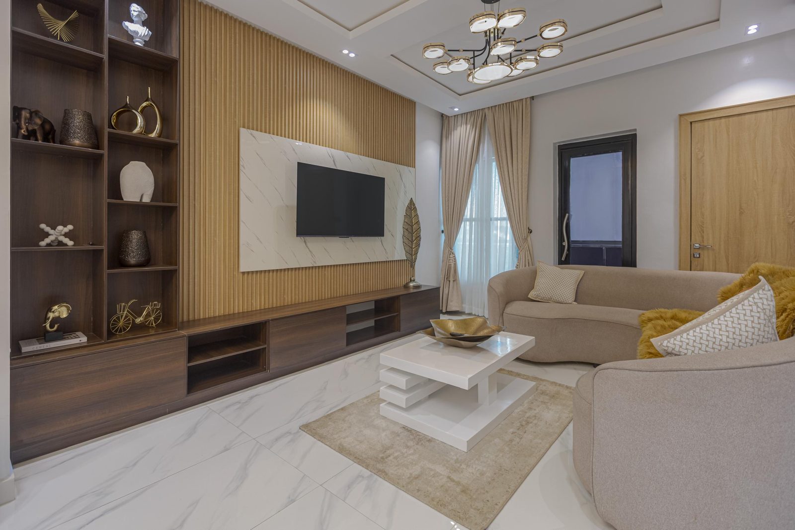 Living room with fluted wood feature wall, Apartment Charlie, Nimbus Nook Ikeja GRA