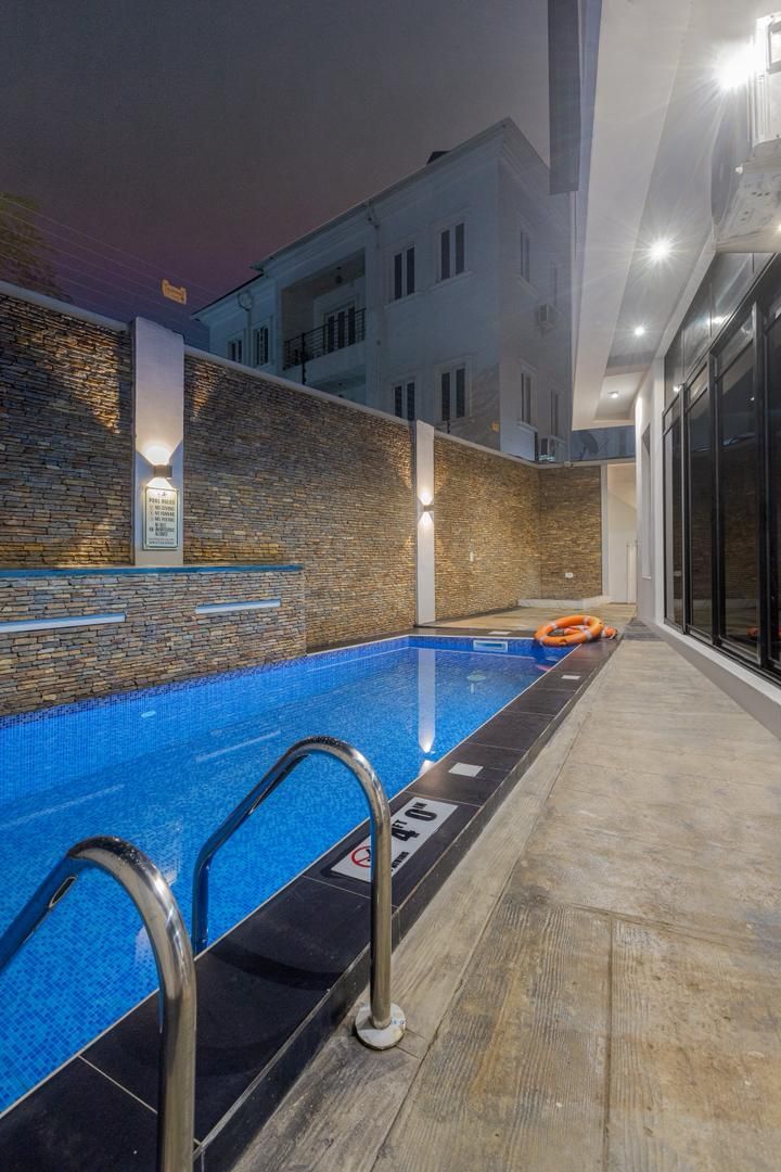 The Nimbus Nook pool lit up in the evening, Ikeja GRA