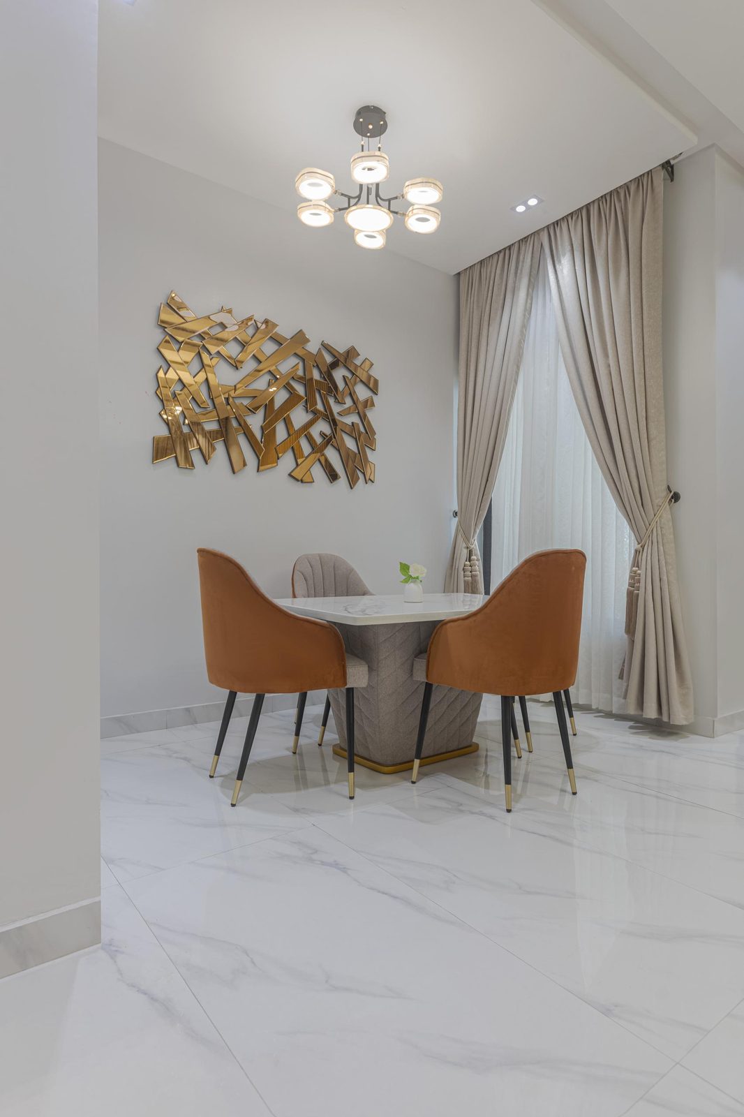 Dining area with gold mirror art at Nimbus Nook shortlet apartments, Ikeja GRA